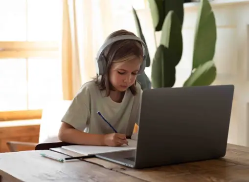 high school student taking online math class on the laptop